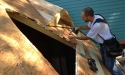 screwing-sheathing-back-down-with-hole-in-roof